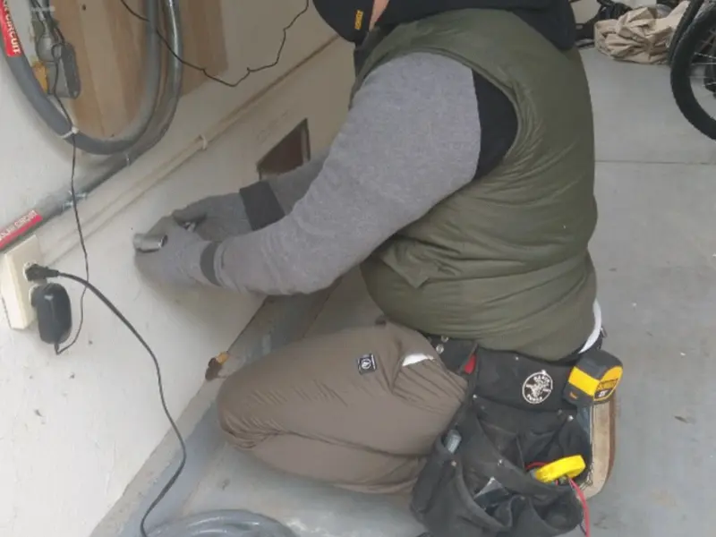 Electrician performing outlet wiring in a Hainesport garage